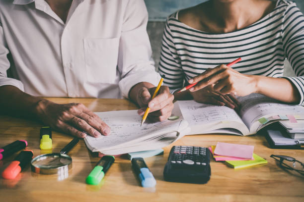 istock High school or college Asian student group sitting at desk in class studying and reading, doing homework and lesson practice preparing exam to entrance, education concept 1021766030