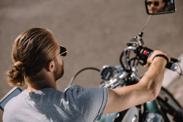 istock young man sitting on vintage classical motorcycle 1021766174
