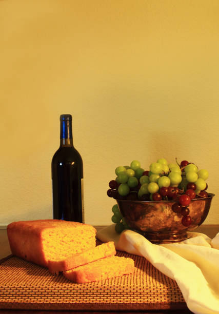 Bread, fruit, and a bottle of wine are arrange in an photograph inspired by the Dutch Masters.