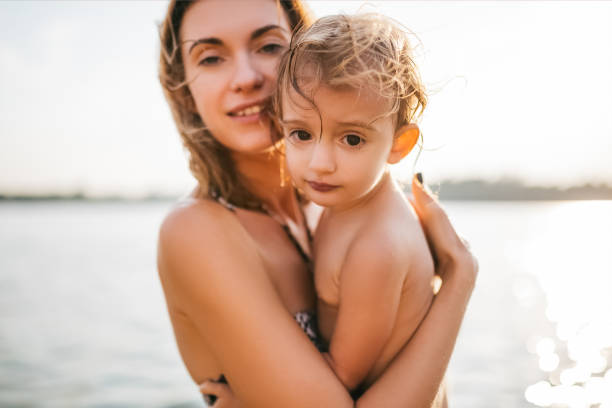 istock mother and child looking at camera in river 1021782688