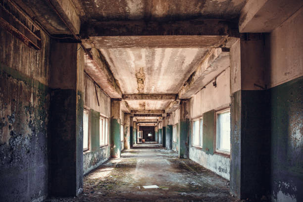 istock Dirty empty dark corridor in abandoned building, perspective 1021794530