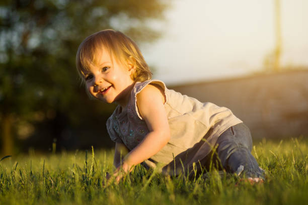 istock playful little girl in grass 1021800398