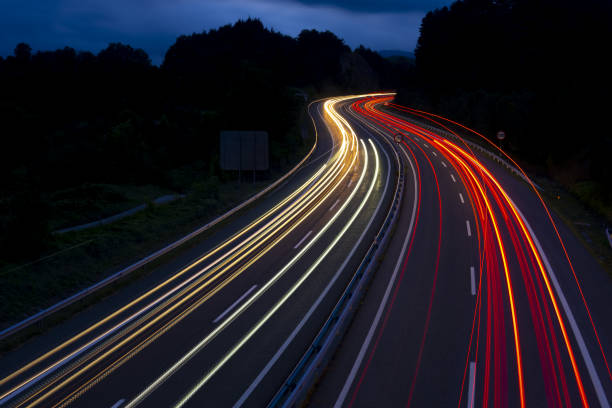 istock Car lights on a mountain road at dusk 1021802640