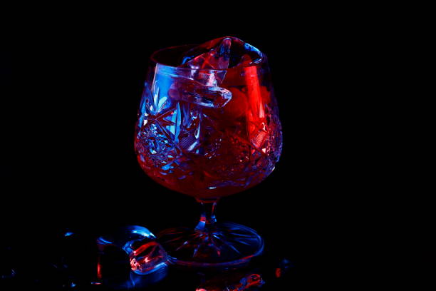 istock Ice in a glass with raspberry red and blue highlight. 1021802832