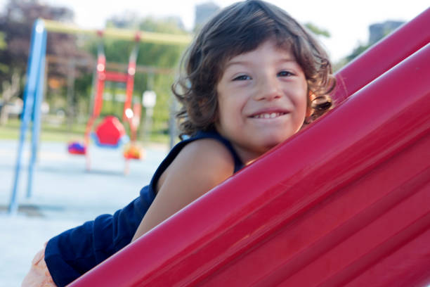 istock Excited little baby boy sliding down a slide. 1021803748