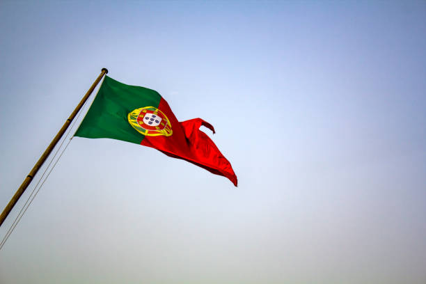 istock Portuguese flag waving against blue sky 1021808550
