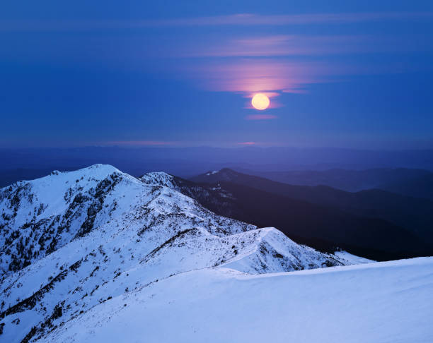 istock Winter landscape with a full moon in the mountains 1021814172