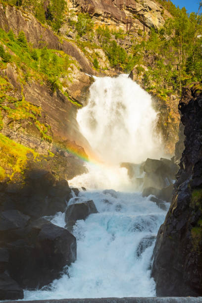 waterfall latefossen at sunset lights in summer, norway - bridge norway odda falling imagens e fotografias de stock