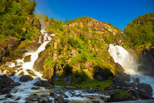 waterfall latefossen at sunset lights in summer, norway - bridge norway odda falling imagens e fotografias de stock