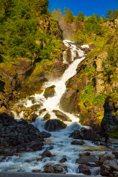 waterfall latefossen at sunset lights in summer, norway - bridge norway odda falling imagens e fotografias de stock