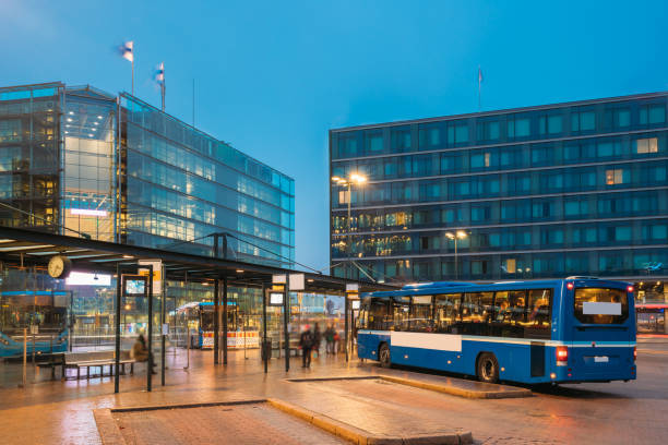 helsinki, finland. bus is at stop on helsinki railway square. square serves as helsinki secondary bus station and main kamppi center bus station - bus station imagens e fotografias de stock
