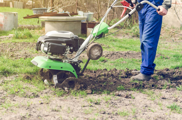 istock Man working in the spring garden with tiller machine 1021823106