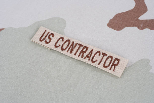 istock US CONTRACTOR branch tape on desert camouflage uniform 1021830448