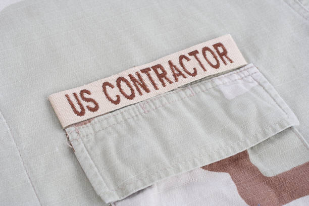 istock US CONTRACTOR branch tape on desert camouflage uniform 1021830632