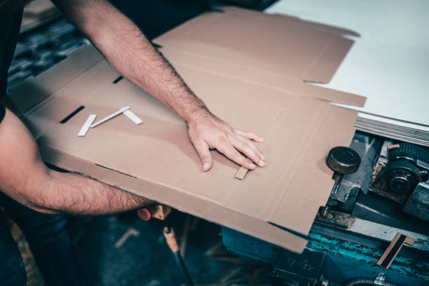 istock Blue Collar Worker Folding And Gluing Cardboard Box 1021844072