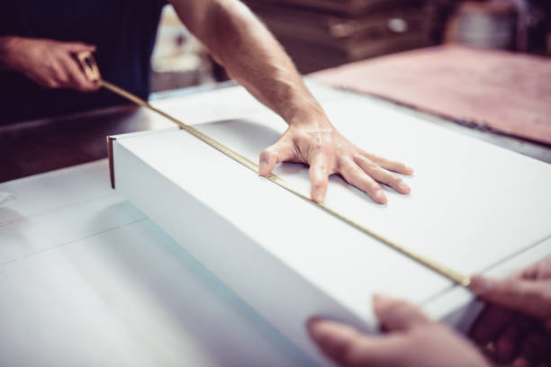 istock Technicians In Factory Measuring Carton Box Length 1021844092
