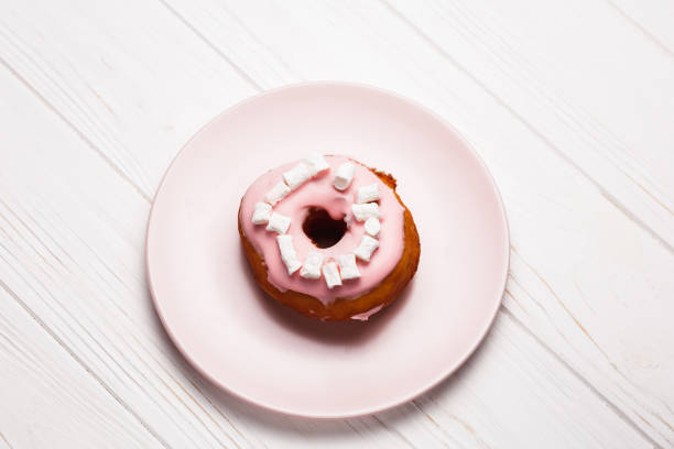 istock Pink donut with marshmallows on a Pink plate 1021844788