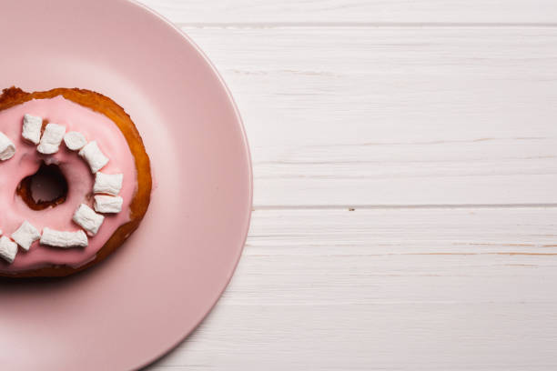 istock Pink donut with marshmallows on a Pink plate 1021844826