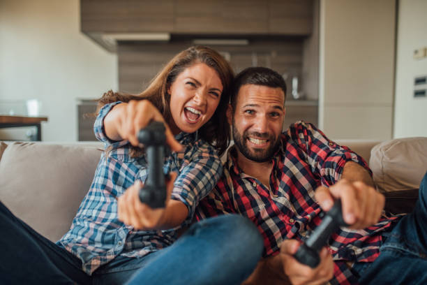 istock Excited couple with joysticks at home 1021845020