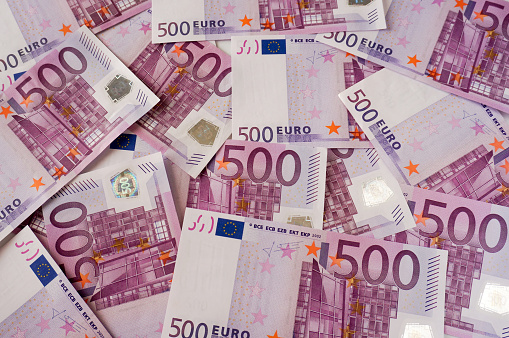 10 and 20 euro banknotes fanned out on a white background. The 20 euro note is mostly out of focus