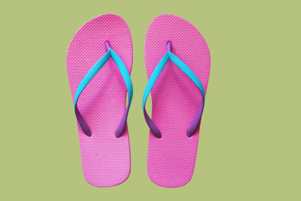 istock Pink flip flops isolated on green background. Top view 1021850406
