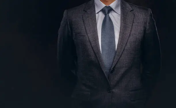 Photo of Cropped portrait of a successful businessman dressed in an elegant formal suit.
