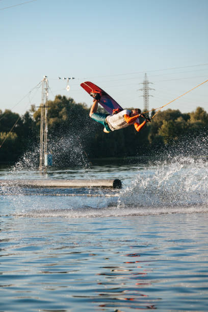 istock Man riding wakeboard on lake 1021853968
