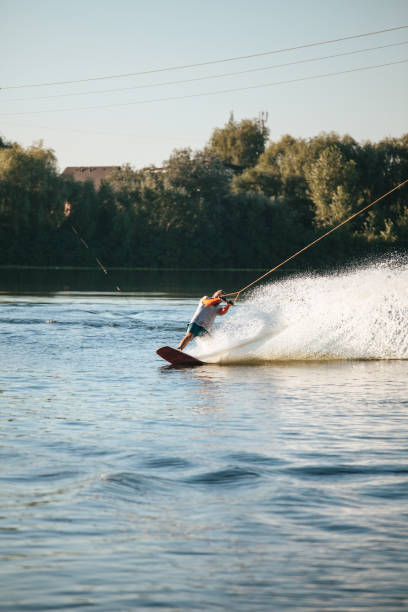 istock Wakeboarder surfing across a lake 1021854248