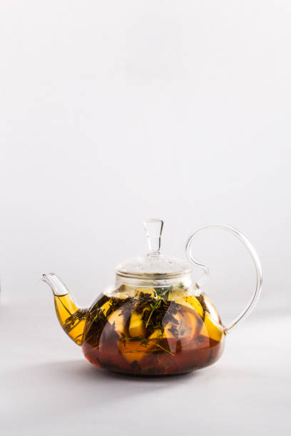 istock Winter tea with cinnamon, lemon, honey in a teapot isolated on white background 1021854764