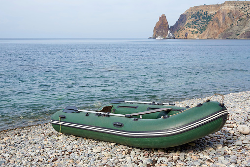 Inflatable rubber boat on the beach.