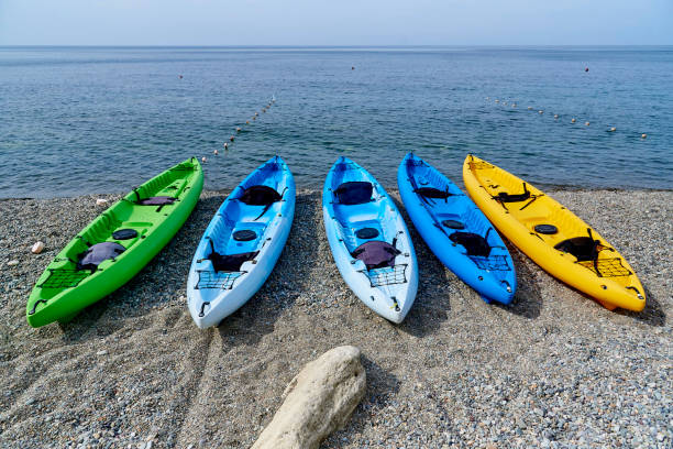 Surfboards on the background of kayaks on the coast. Surfboards on the background of kayaks on the coast. labadee stock pictures, royalty-free photos & images