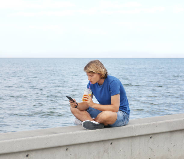 istock Teenage boy typing text message.Using smart phone. 1021886888