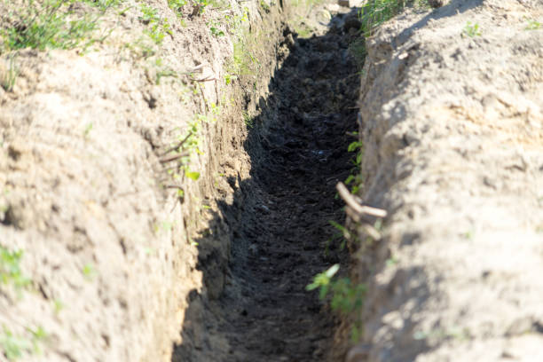 istock Dig a trench for construction. Place for your text. 1021889610