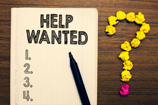 istock Word writing text Help Wanted. Business concept for advertisement placed in newspaper by employers seek employees Notebook marker crumpled papers forming question mark wooden background. 1021889728