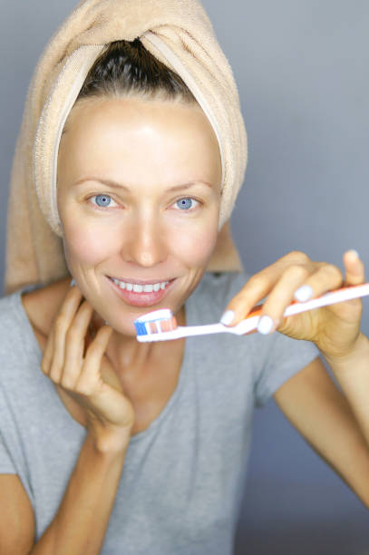 istock Woman brushing cleaning teeth 1021889856