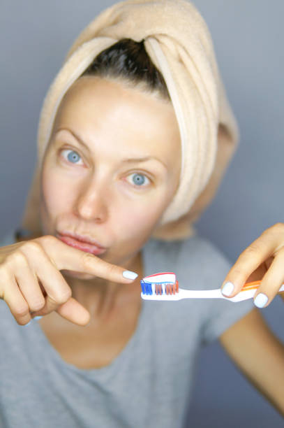 istock Woman brushing cleaning teeth 1021889858