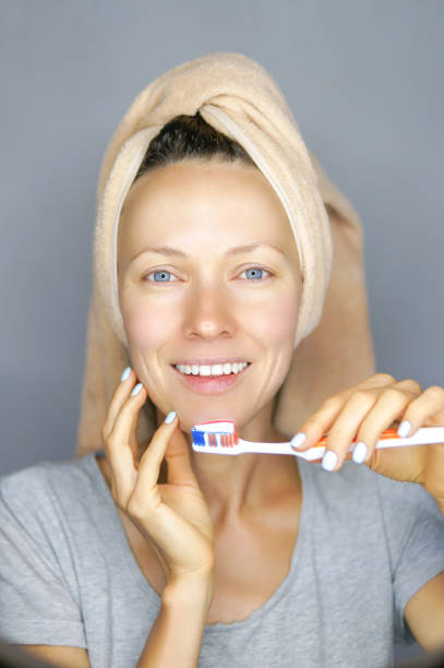 istock Woman brushing cleaning teeth 1021889880