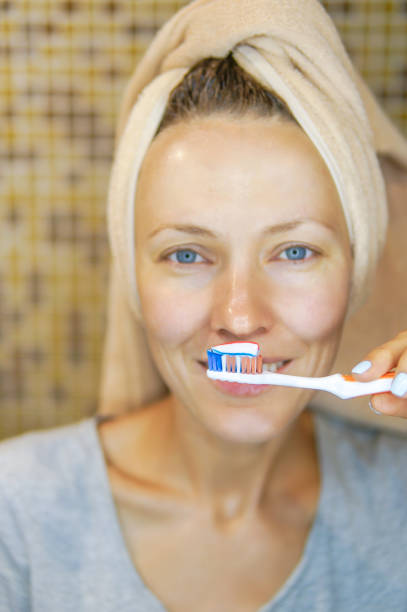 istock Woman brushing cleaning teeth 1021889926