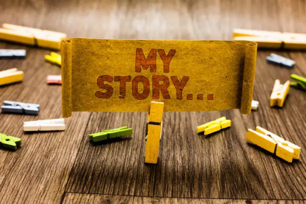 Photo of Word writing text My Story.... Business concept for telling someone or readers about how you lived your life Clothespin holding old piece fabric several clothespins wooden floor.