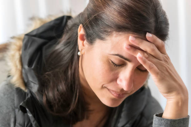 Serious mature woman holding her head with her hand Serious concerned hispanic or middle eastern mature woman holding her head with her hand one mature woman only stock pictures, royalty-free photos & images