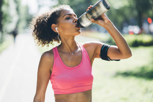 istock Sports woman drinking water after training 1021898098