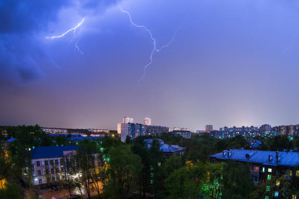 istock Lightning storm over city in blue light 1021902610