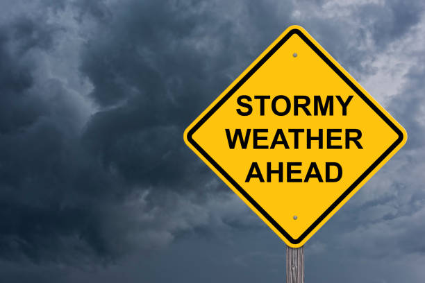 Stormy Weather Ahead Warning Sign Stormy Weather Ahead Caution Sign With Storm Cloud Background extreme weather stock pictures, royalty-free photos & images