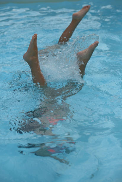 istock feet in the air in the pool 1021913020