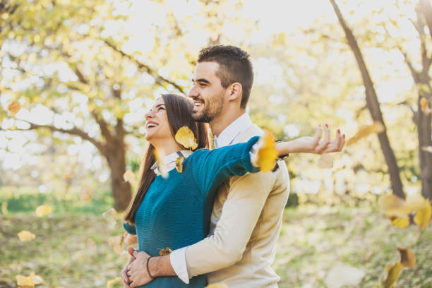 istock Beautiful Young Couple Enjoying the Fall at Park 1021924504