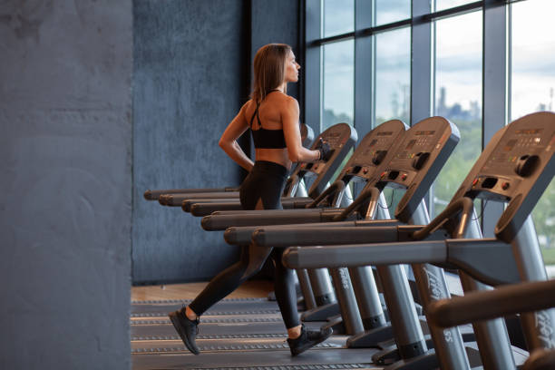 istock young hispanic athletic sportswoman on treadmill 1021924658