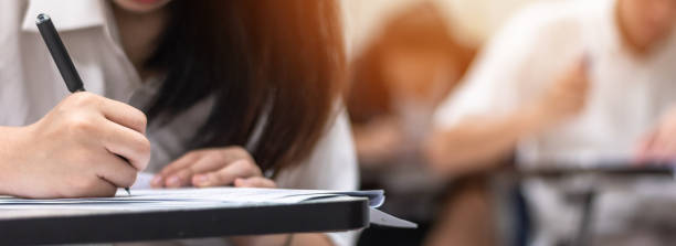 istock Education, school exam, or educational test, admission with students thinking hard, writing answer in university classroom, education and world literacy day concept 1021950244