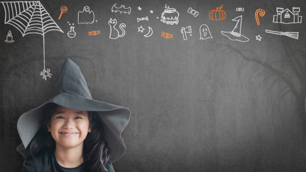 Trick or treat halloween girl kid having fun in witch hat black costume with funny doodle of spider web, jack o lantern and party decoration on spooky school chalkboard background Trick or treat halloween girl kid having fun in witch hat black costume with funny doodle of spider web, jack o lantern and party decoration on spooky school chalkboard background halloween pumpkin human face candlelight stock pictures, royalty-free photos & images