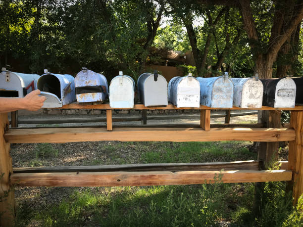 istock Line of Classic Rural US Mailboxes; Hand Opening One 1021960292