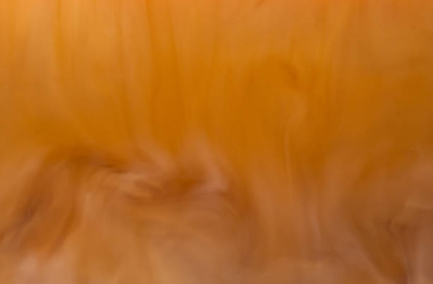 istock Mixing Coffee with Cream Close up 1021977406